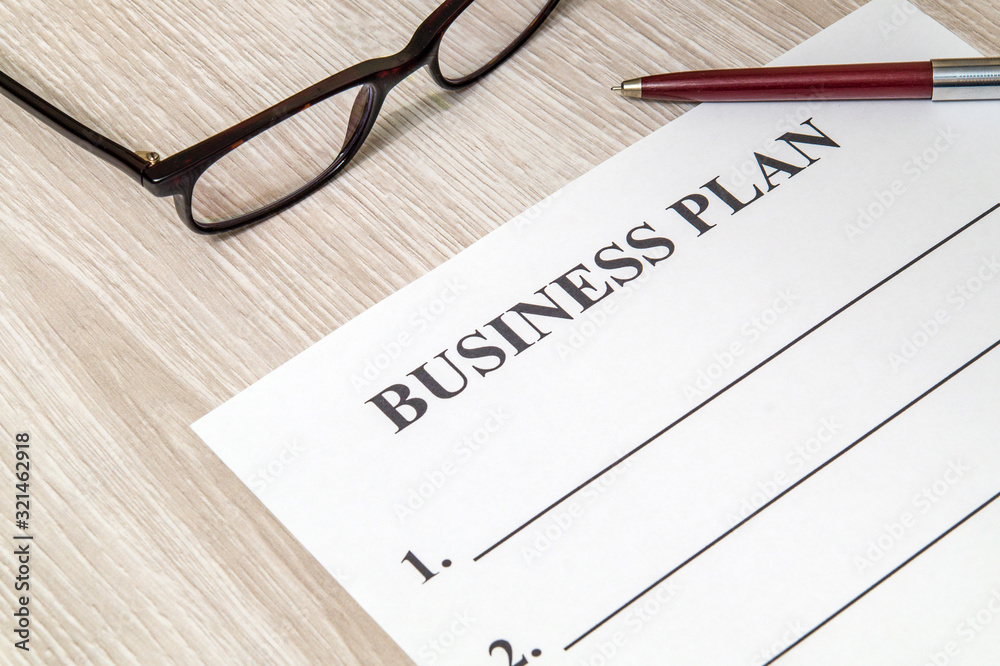 Blank form and pen for drawing up business plan on table Blank form and pen for drawing up business plan on table