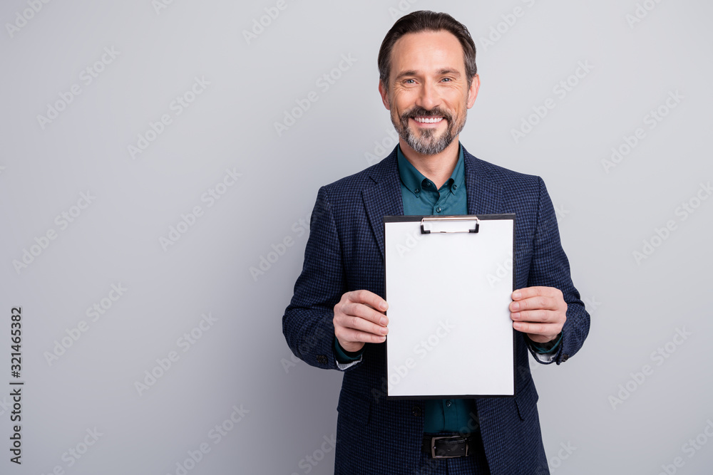 Photo of attractive business manager man showing contract clipboard empty place for signing client information formalwear blazer shirt blue suit isolated grey color background Photo of attractive business manager man showing contract clipboard empty place for signing client information formalwear blazer shirt blue suit isolated grey color background