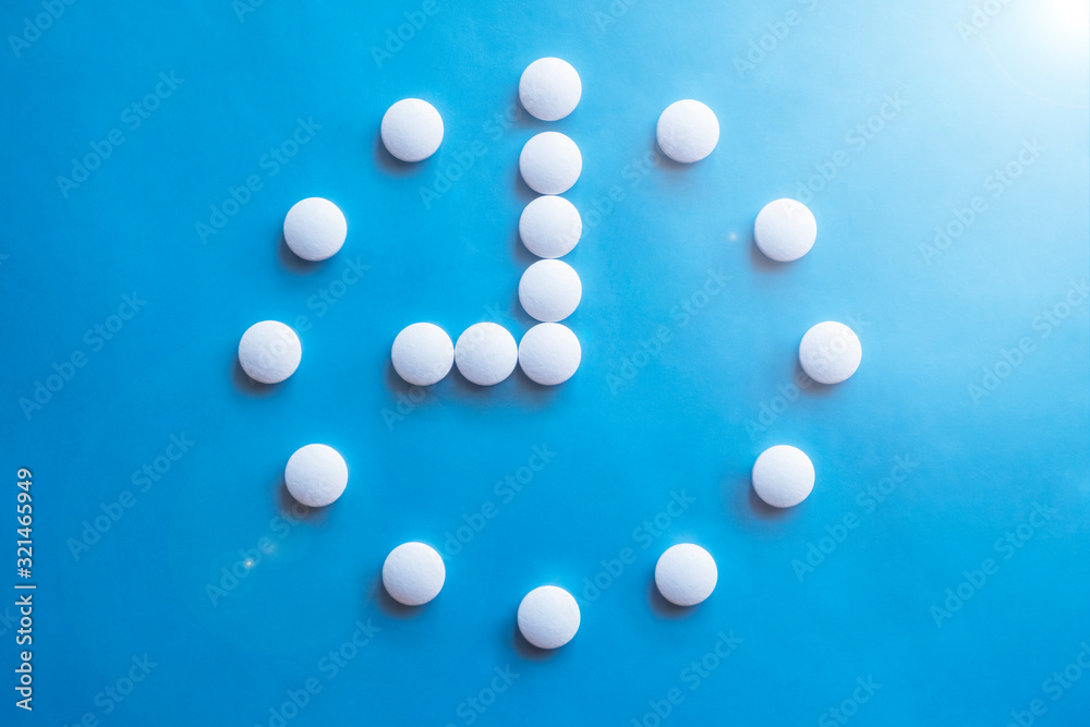 9 o clock made of pills. Abstract medical background. Medication time concept. Medicine drug icon. Time to take medicine.