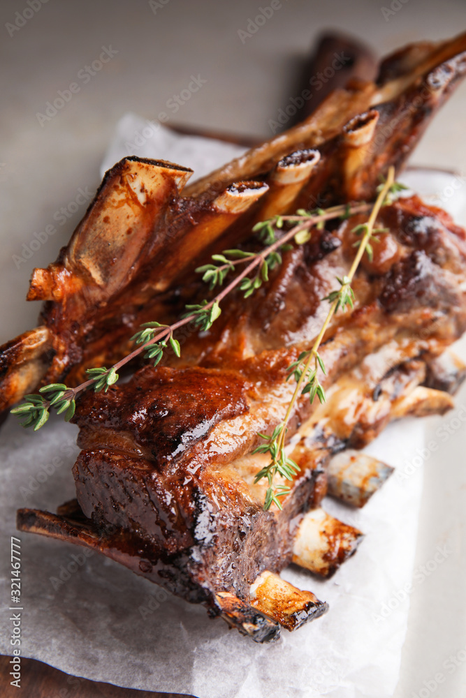 Delicious roasted ribs served on table, closeup