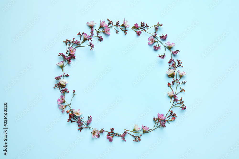 Frame made of beautiful flowers with space for text on light blue background, top view. Floral card design Frame made of beautiful flowers with space for text on light blue background, top view. Floral card design