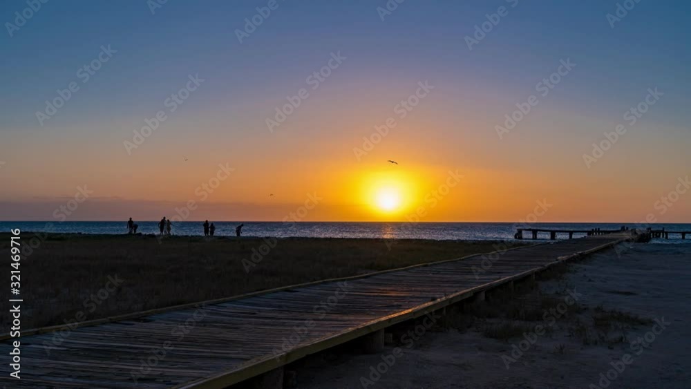 Time lapse: Wooden dock with beautiful sunset at the background Time lapse: Wooden dock with beautiful sunset at the background