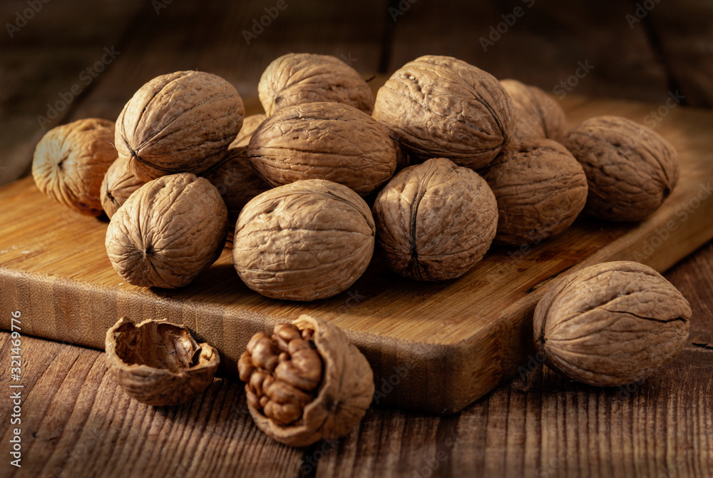 Kernels of walnuts on a dark countertops with a dark background on the board, vintage. Kernels of walnuts on a dark countertops with a dark background on the board, vintage.