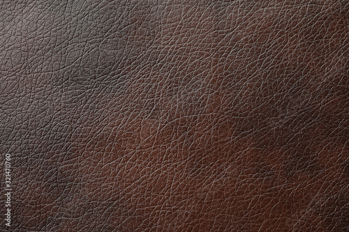 Texture of dark brown leather as background, closeup