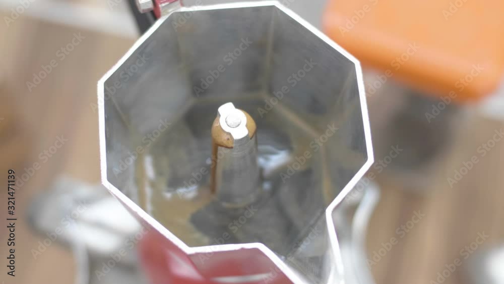 The red coffee boiler is boiling. The coffee machine at home manually. The red coffee boiler is boiling. The coffee machine at home manually.