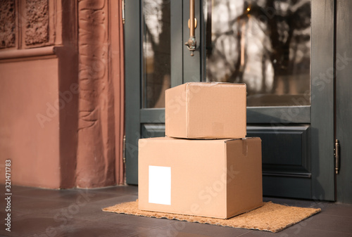 Delivered parcels on door mat near entrance