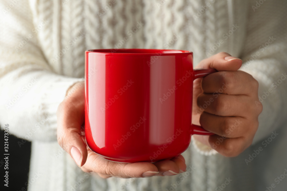 Woman holding cup of hot winter drink, closeup Woman holding cup of hot winter drink, closeup