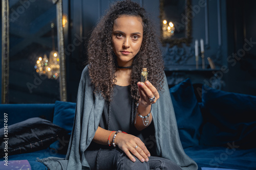 Girl demonstrating a bottle of healing potion photo