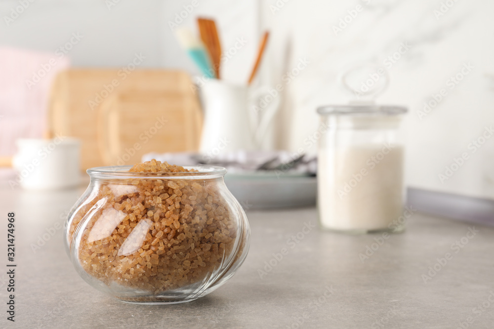 Glass bowl with brown sugar on grey table Glass bowl with brown sugar on grey table