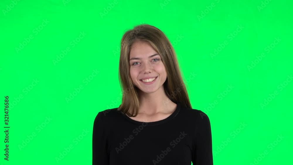 Young woman smiling and posing at the camera. Green screen Young woman smiling and posing at the camera. Green screen