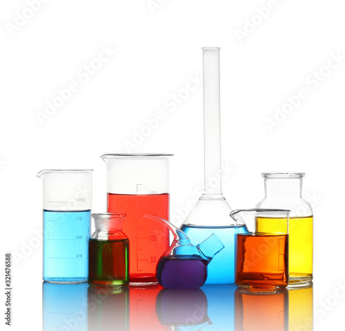 Different laboratory glassware with colorful liquids isolated on white