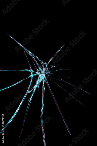 crack in the form of abstraction on broken glass mirror on a black background