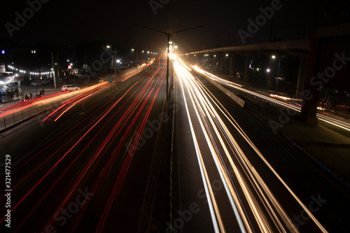 Speed Traffic light trails on highway, long exposure, urban background and dark sky © P.Bharti