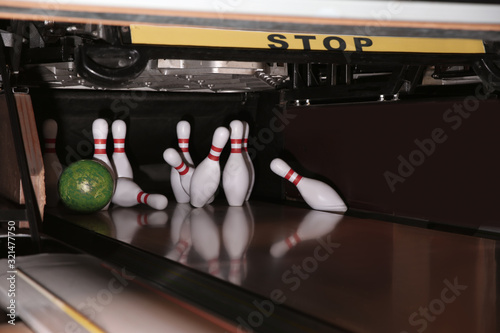 Ball hitting pins on alley in bowling club