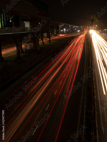 Speed Traffic light trails on highway, long exposure, urban background and dark sky