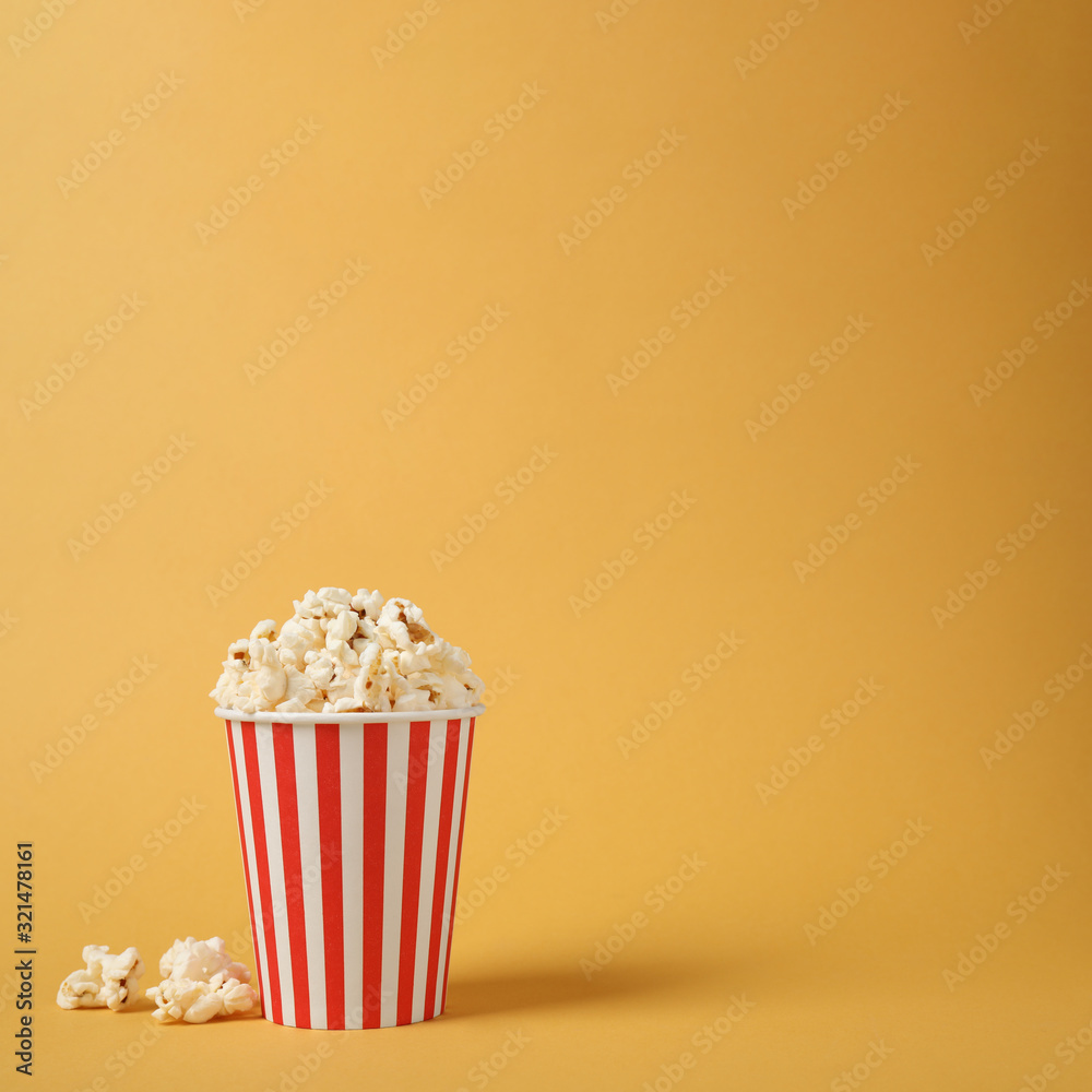 Delicious popcorn on yellow background. Space for text