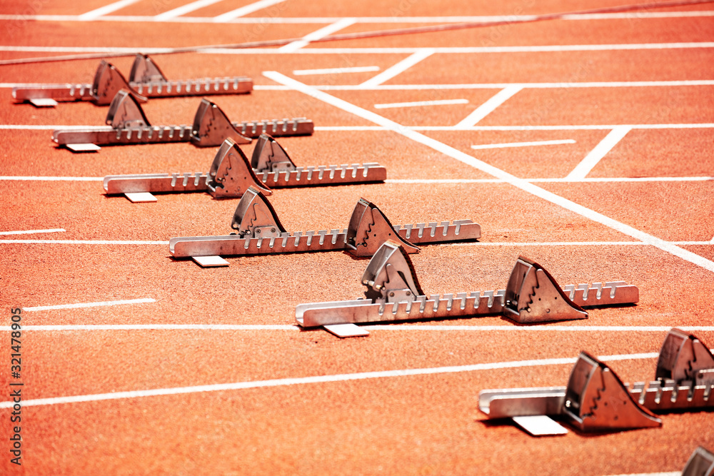 Fototapeta premium Close-up of starting blocks on stadium track for sprint running