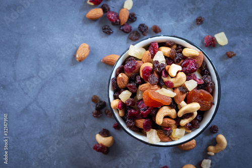 mixed nuts and dried fruits in enamel bowl.
