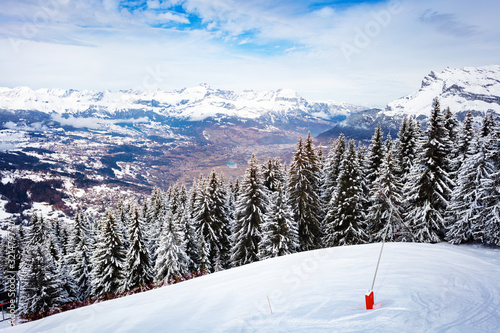 Panorama of valley and snow covered firs of Mont-Blanc, Chamonix region, Auvergne-Rhone-Alpes in south-eastern France