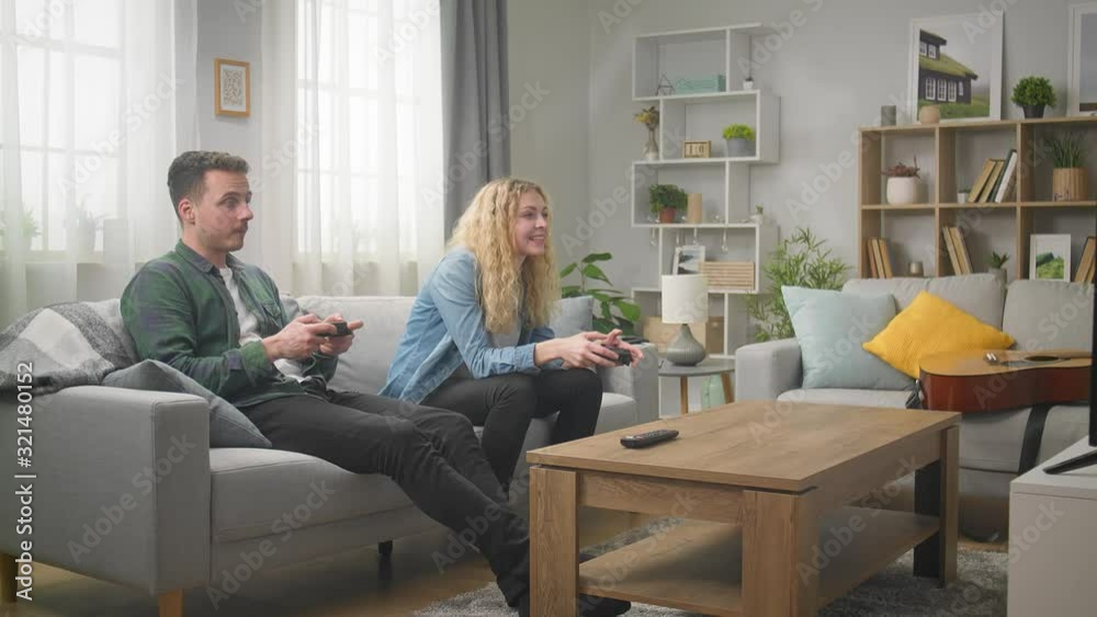 Cheerful friends playing video games at home Cheerful friends playing video games at home