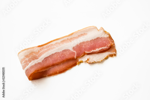 A slice of raw pork bacon. Closeup isolated on white background.