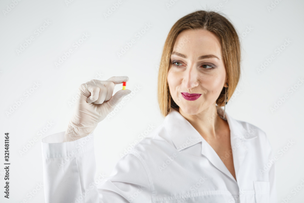 a doctor with a pill on a white background. a doctor with a pill on a white background.