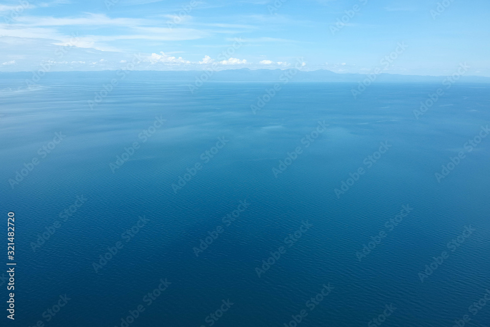 Obraz premium drone shot of the blue seascape with little clouds