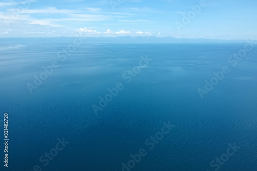 drone shot of the blue seascape with little clouds