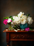 Still life with white peonies in a blue jug on the table