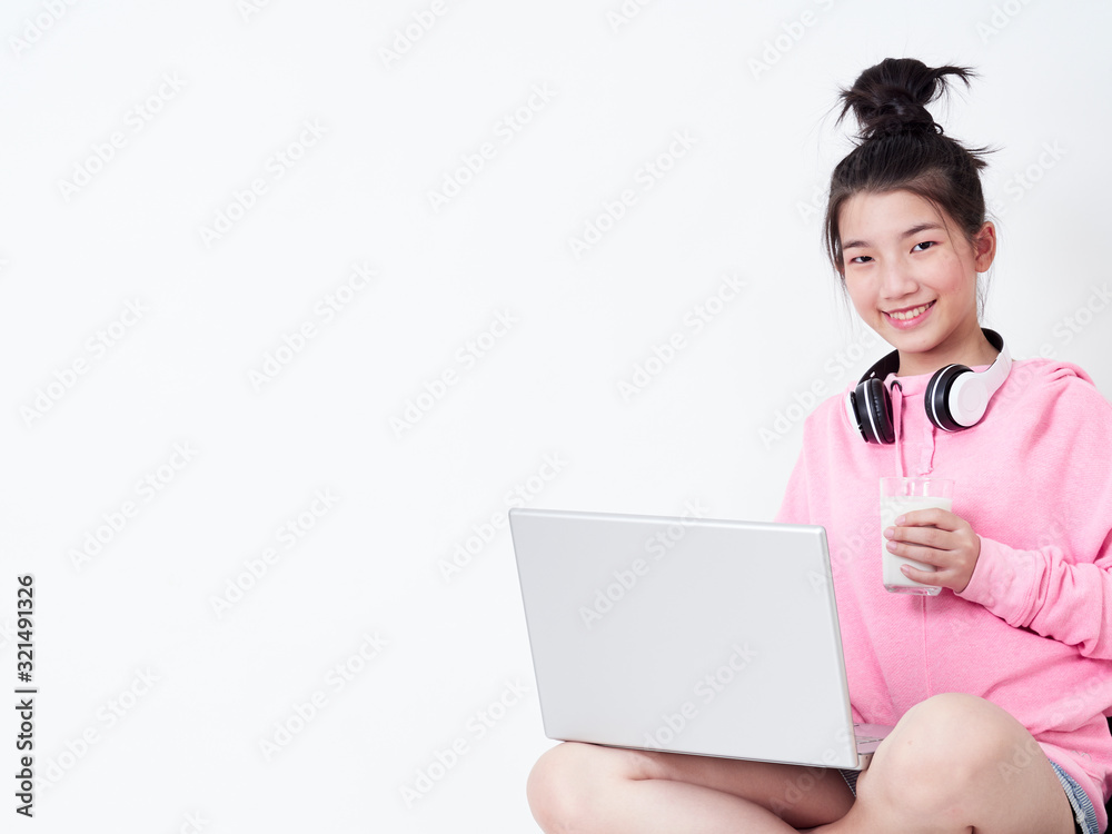 Cheerful girl using laptop sitting on chair. Cheerful girl using laptop sitting on chair.