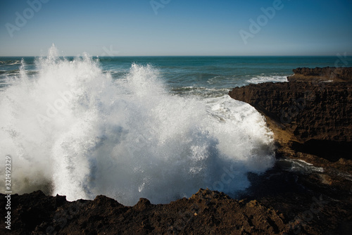 beautiful rugged coastline with waves crashing against the cliffs