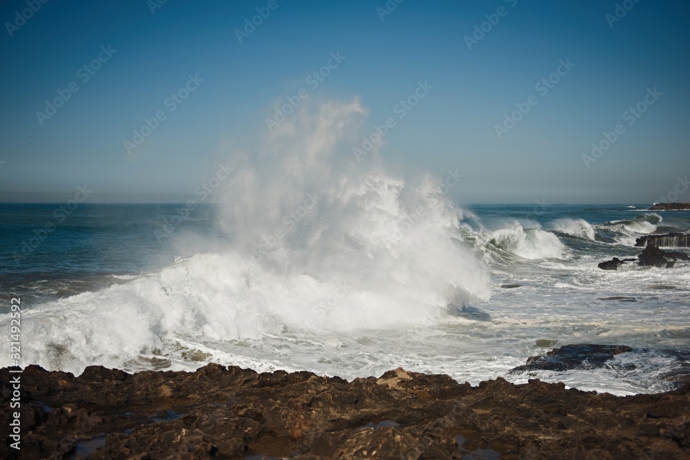 beautiful rugged coastline with waves crashing against the cliffs