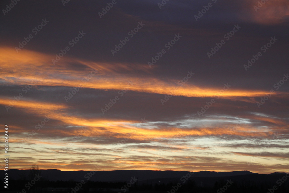 Colorful sunset cloudy sky with waves