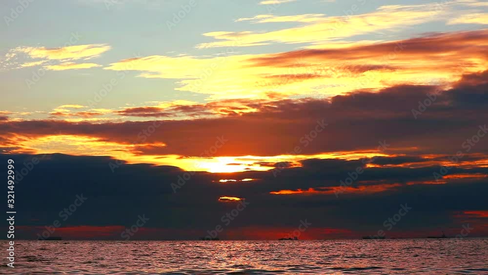 sunset on the sea red cloud and reflection of sunlight on water