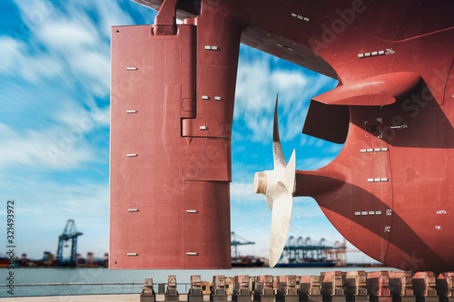 ship moored on sleeper At Stern ship Propeller with rudder under Reconstruction, Under the ship, Big ship under Repair on floating dry dock in shipyard