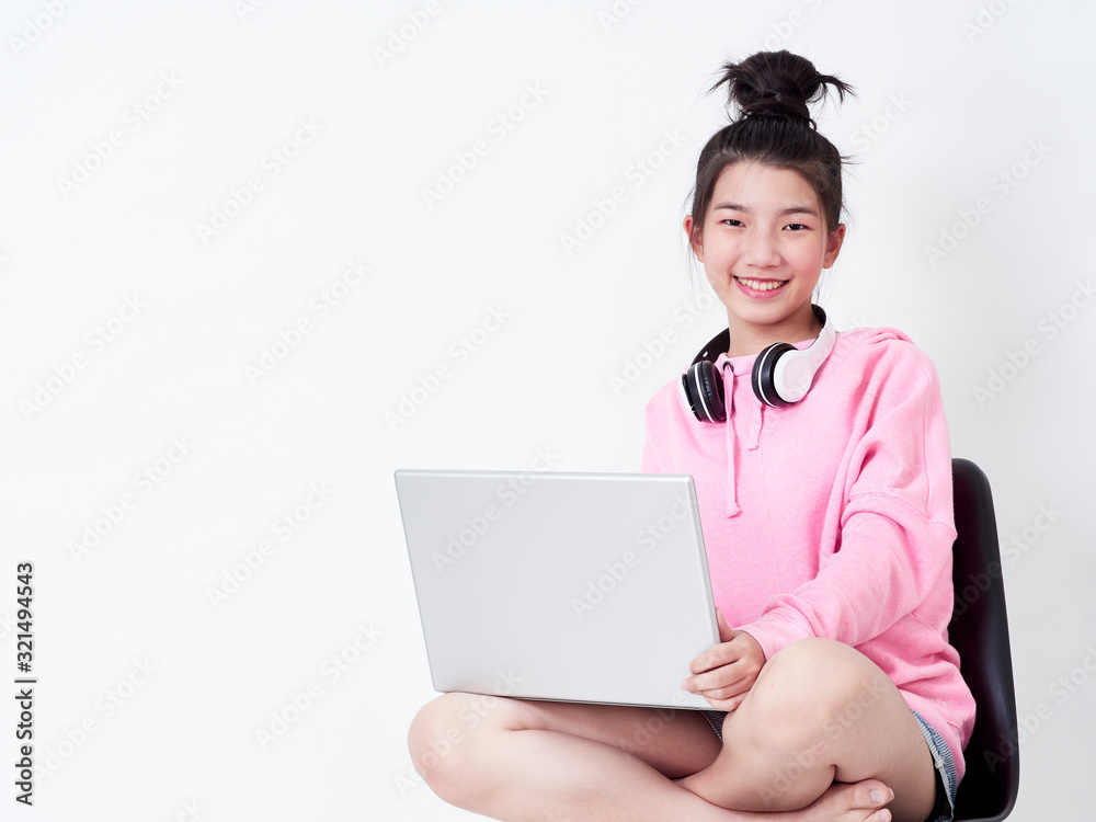Cheerful girl using laptop sitting on chair. Cheerful girl using laptop sitting on chair.