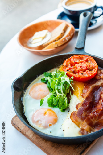 Grilled toasts served with beans, scrumbled eggs and sausage for an English breakfast.