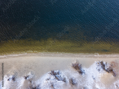 Fotografie Aerial drone view. Sandy bank of the Dnieper in snowy weather.