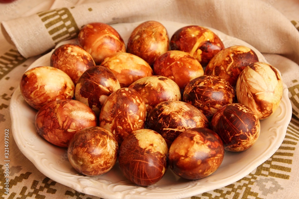 Yellow and brown Easter eggs painted in natural onion bark. Easter egg in old traditional latvian style