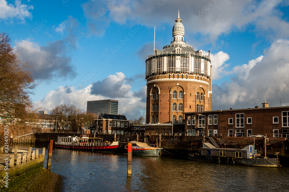 Fototapeta premium Beautiful cityscape of an old water tower in Rotterdam by the river