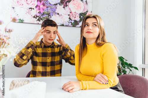 Scene in cafe - misunderstanding between the enamoured girl and boy, having an argument. photo