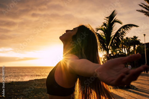 Closeup portrait of active healthy beautiful woman enjoying the sunset and the sport - people having relax time outdoor after activity exercises class or session - breathe and happiness photo