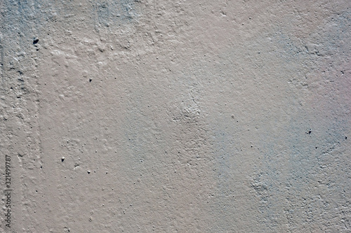 texture of a painted wall. cement plate light gray color background. wall with bumps and small pits.