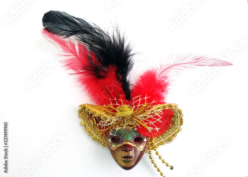 plastic mask in a hat with feathers on a white background top view. Brown masquerade mask in a hat with a red and black feather. Carnival outfit for the doll.