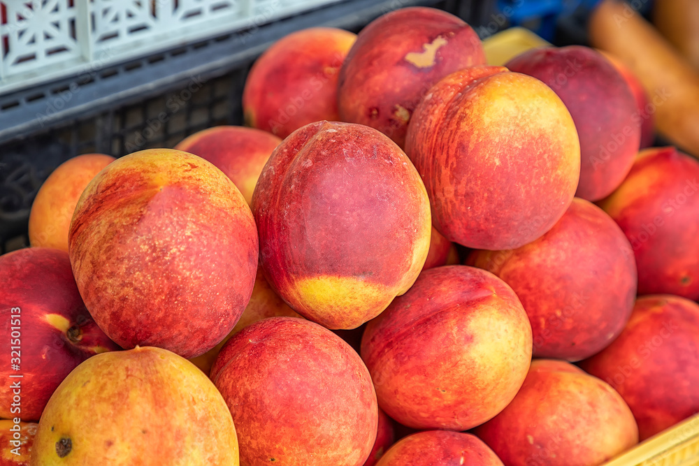 Sorted sweet peach fruits at the market. Selective focus Sorted sweet peach fruits at the market. Selective focus