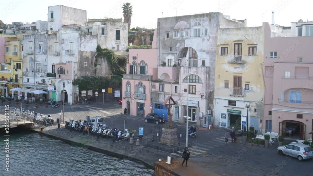 Campi Flegrei, Naples, Campania, Italy - Decemeber 5 2019: the pastel colors of Marina Corricella in the port of Procida Campi Flegrei, Naples, Campania, Italy - Decemeber 5 2019: the pastel colors of Marina Corricella in the port of Procida