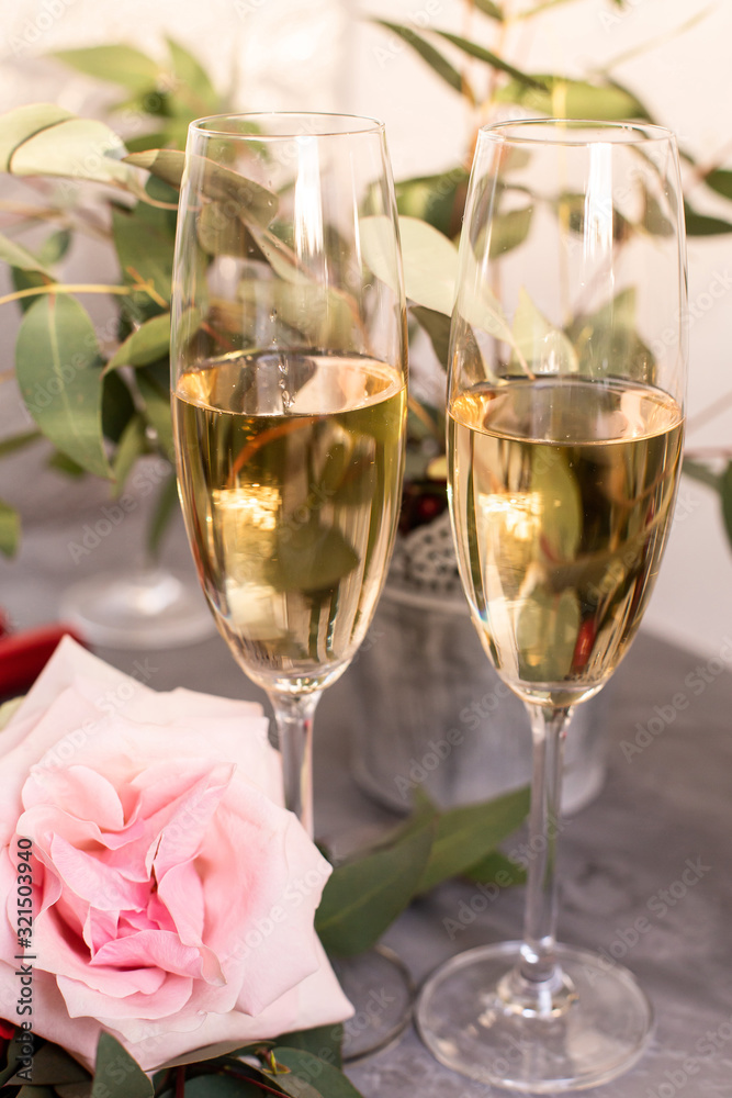 Composition with glasses of vine and flowers on grey concrete background. Composition with glasses of vine and flowers on grey concrete background.