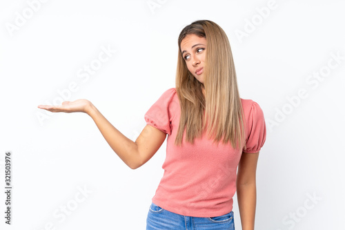 Young blonde woman over isolated white background holding copyspace with doubts