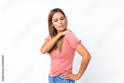 Young blonde woman over isolated white background suffering from pain in shoulder for having made an effort © luismolinero