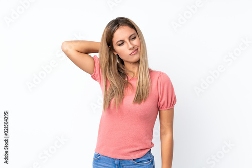 Young blonde woman over isolated white background with neckache © luismolinero